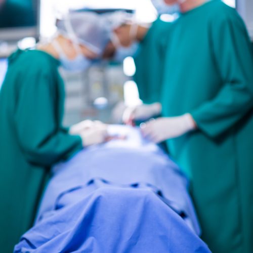 Surgeons performing operation in operation theater of hospital